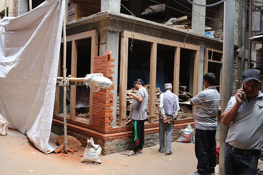 Mason and Supervisors Bricking in a Set of Doors, Old Patan, Nepal.